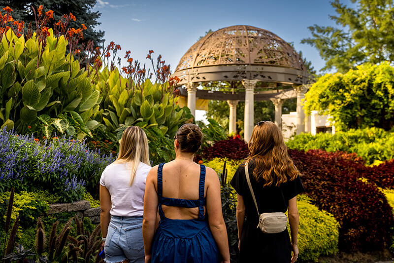 Three women gaze in amazement at the beauty of the Sunken Gardens.