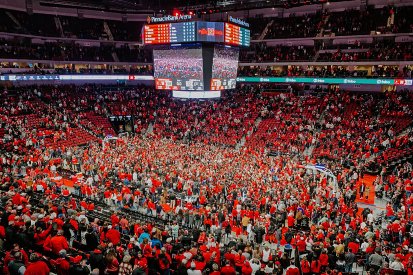 Husker fans rush the court after an epic win in basketball.